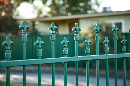 The top of a green school fence