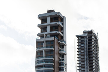 View of tall building under construction on sunny day and blue sky in Salvador city, Brazil.
