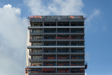 View of a tall building under construction against blue sky in the city of Salvador, Brazil.