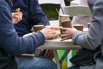 A group of people eating from paper cups