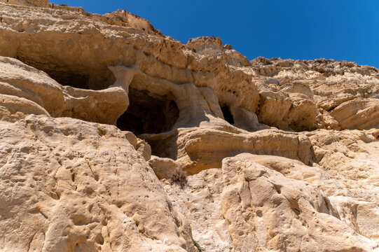 Rock formations and caves in Matala, Crete, Greece during a sunny day - Powered by Adobe
