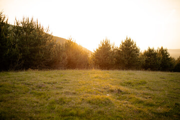 sunset over the hills of a village