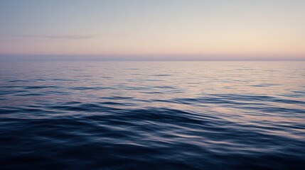 Obraz premium Vast ocean meeting sky at the horizon creates endless vistas, bathed in soft light with gentle ripples on water, evoking serenity through minimalist composition focused on depth and natural beauty.