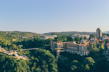 panorama of the old town of veliko tarnavo bulgaria with green forest in hot summer day
