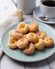 Typical brazilian sugar covered biscuit with coffee over wooden table