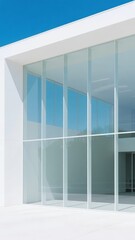 Modern Building with Large Glass Windows Under a Clear Blue Sky
