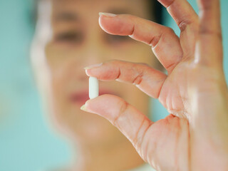 Senior Asian woman holding drugs for concept healthcare and medical. Close up hand medicine bottle with pill at home care for healthy lifestyle people wellness health. Elderly care female patient 