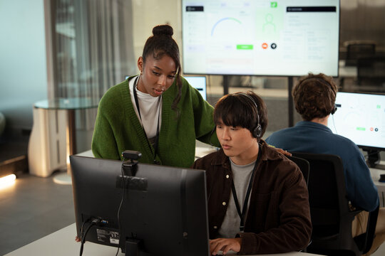 Team of tech customer support professionals collaborating modern office environment, with focus problem solving and effective communication. workspace features computers and digital interfaces