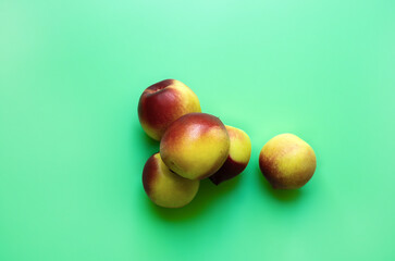 A bunch of peaches on a green background, top view