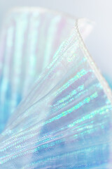 Pleated Iridescent Translucent Fabric Close-Up – Shimmering Texture in Blue, Purple, and Green...