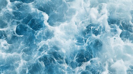 Fototapeta premium Ocean Waves: An abstract, high-angle shot captures the power and beauty of ocean waves in a mesmerizing display of swirling blues and foamy whites, evoking a sense of tranquility and wonder.