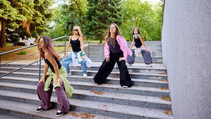 Street geometry. Youthful dancers are performing vibrant street choreography on urban stairs...