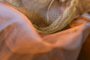 Golden Mesh Fabric with Flowing Folds – Soft Semi-Transparent Textile Texture for Fashion Design,...