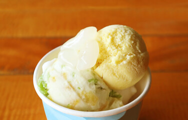 Scoops of Coconut Milk and Durian Flavored Ice Cream Topped with Sweetened Sugar Palm Seeds