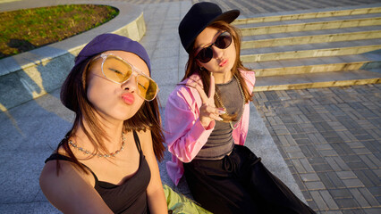Youthful dancers pose playfully in an urban setting wearing vibrant casual streetwear and accessories. Concept of modern urban youth culture and expression.