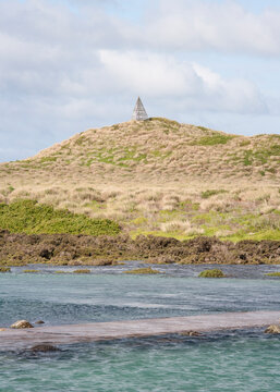 Trig point on hill seen from the sea