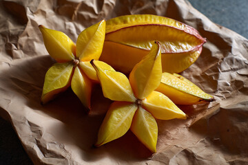 Fresh starfruit placed on crumpled brown paper showing its vibrant color and unique shape