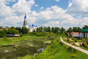 Kashin, Tver region, Russia - 9 July 2021: Scenic cityscape Kashin town in summer, Resurrection Cathedral on bank of the Kashinka River