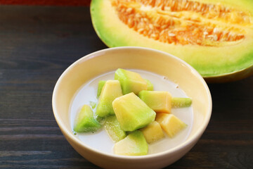 Tasty and Fragrance Thai Melon in Chilled Sweetened Coconut Milk with Fresh Fruit in the Backdrop