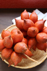 Clusters of Fresh Ripe Salak or Snakeskin Fruit in a Wicker Plate
