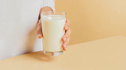Cozy Morning Milk - Simple Comfort, A person's hand gently holds a glass of milk, resting on a table. The scene evokes feelings of warmth and contentment.