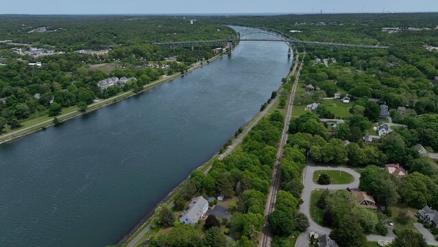 Aerial of Cape Cod Canal with Bourne Bridge crossing. Canal used for shipping and transportation form Cape Cod Bay to Buzzards Bay in Massachusetts