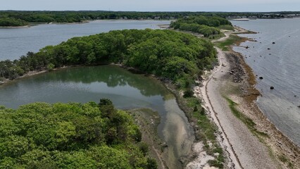 Aerial peaceful Massachusetts coastline with natural islands with beach and trees wildlife preserve...