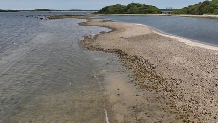 Aerial peaceful Massachusetts coastline with natural islands with beach and trees wildlife preserve...