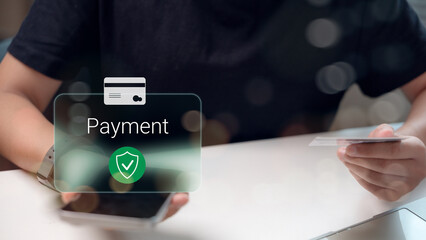 Secure online payment concept with hand holding credit card and smartphone, digital payment icon overlay, safe transaction, fintech technology, and e-commerce service.