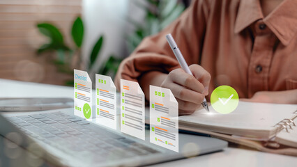 A woman writing in a notebook with floating digital checklists above a laptop. Concept of productivity, planning, task management, and digital workflow.