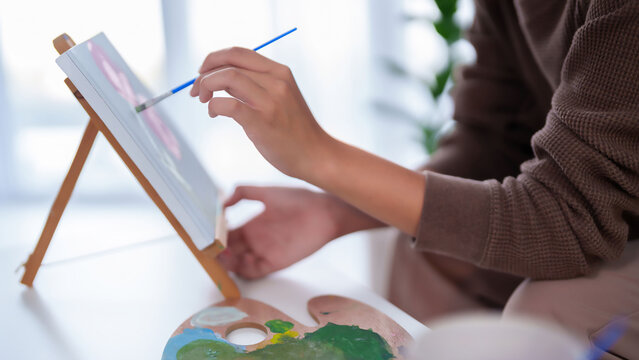 Asian Artist Hand Painting Artwork on Canvas with Brush for Hobby - Powered by Adobe