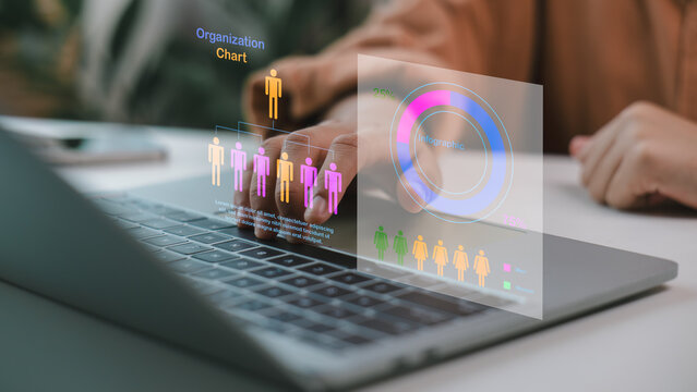Businesspeople analyzing a virtual organization chart and infographic on a laptop, touching the digital interface, with a data analysis concept and HR technology.