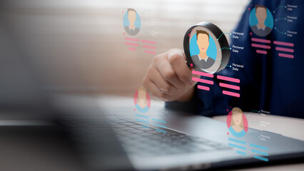 HR hand holding magnifying glass selecting candidate profile from digital screen, concept of recruitment, data analysis and human resource management.