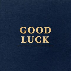 Navy card with gold serif good luck message celebration event elegant design indoor setting close-up view positive vibes