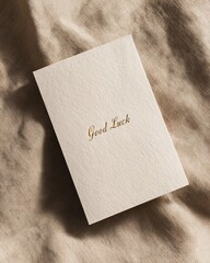 Good luck card on soft textured fabric top view photography warm ambiance minimalist design