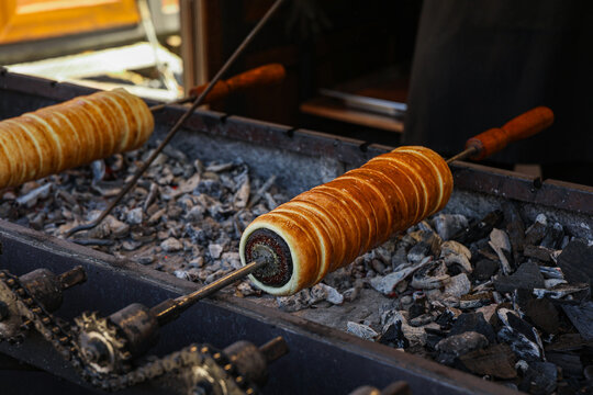 Kurtos Roasting Over Hot Coals with Traditional Baking Mechanism &ndash; Authentic Hungarian Pastry Preparation