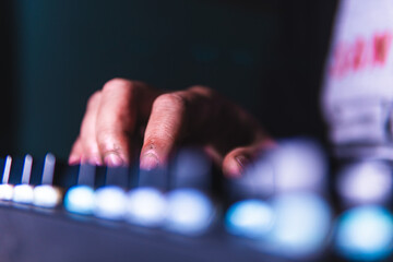 Close-up of fingers typing on a mechanical keyboard with glowing backlight. Ideal for content about...