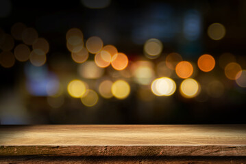 Empty wooden table with bokeh and blur restaurant background, for your photo montage or product...
