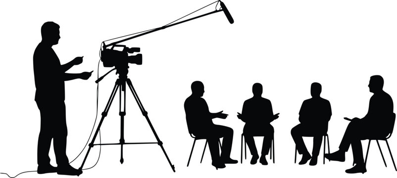 Silhouette of a camera operator filming a group of seated individuals in an interview or media production setting