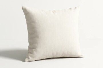 A white pillow sitting on top of a white table