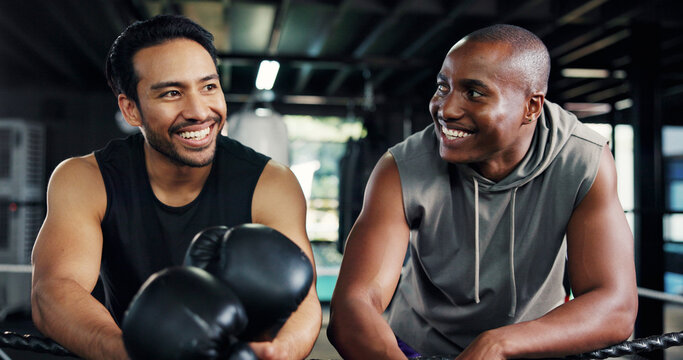 Friends, boxing ring and men on break for sports, fitness or training advice in health club. Gym, happy boxer or rest together with conversation for fight technique, exercise or coaching for progress - Powered by Adobe