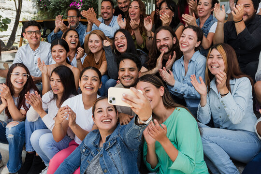 Hispanic friends taking big group selfie shot smiling at camera outdoors in Mexico Latin America, Laughing latin young people and Human resources concept