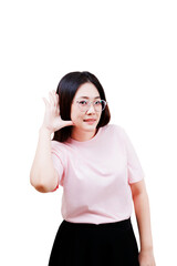 Asian young beautiful woman wearing glasses and a pink shirt holds her hand near her ear as if...