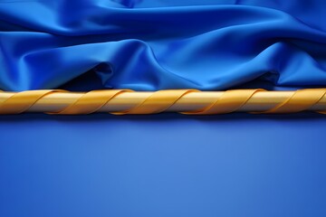 Luxurious royal blue satin fabric draped elegantly with a golden ribbon accent creating a sophisticated and rich visual