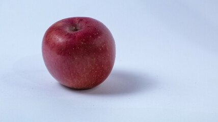 Red apple with a bite on side, showing white flesh inside, isolated on white background.Half apple with red apple isolated. Apple on white background. Red apple with clipping path. Full depth of field
