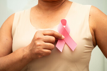 Asian woman with pink ribbon for October world breast cancer day.