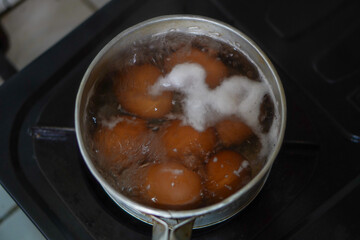 The process of boiling eggs in a pan of boiling water. top view photo
