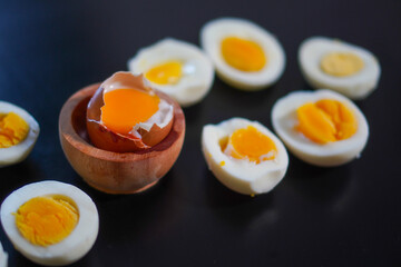 Closeup, Several levels of doneness of boiled eggs on a black background