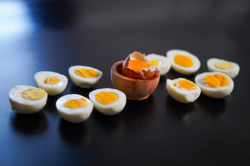 Several levels of doneness of boiled eggs on a black background