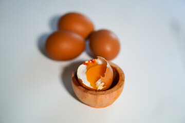 One half boiled egg with 3 whole eggs